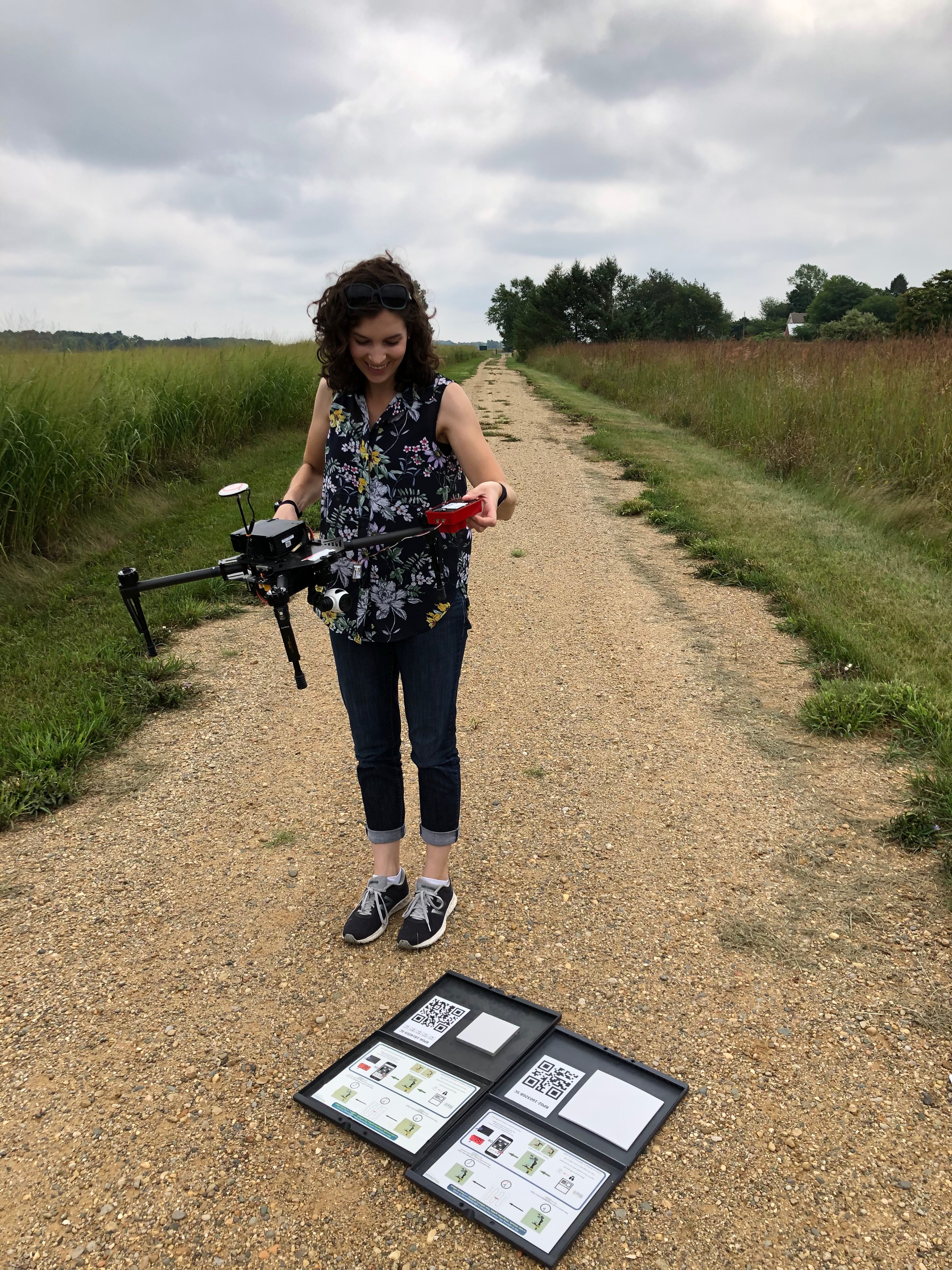Lydia taking pictures of calibration panels with the DJI M100 drone before the flight